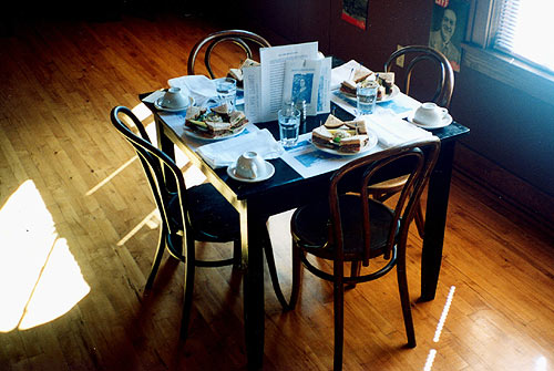Quaint and authentic setting for a table of four with the famous and delicious �mock steak deluxe� sandwich and authentic table setting and 1934 menus and literature of that era.