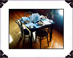 Quaint and authentic setting for a table of four with the famous and delicious 'mock steak deluxe' sandwich and authentic table setting and 1934 menus and literature of that era.