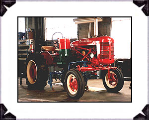 1940s International Farmall tractor with fertilizer attachment and cultivators mounted. Fully restored.