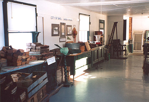 Potting bench with hand made tools including seeding tools from the 1930s.