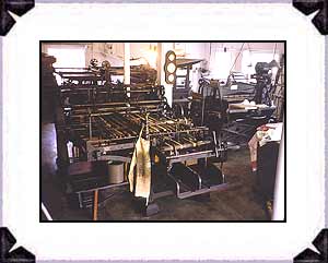 Interior of Printshop, center is a folding machine, the press in the rear is from 1891.