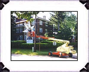 Colony electrician working on the Star lighting at the Administration building, 1999.