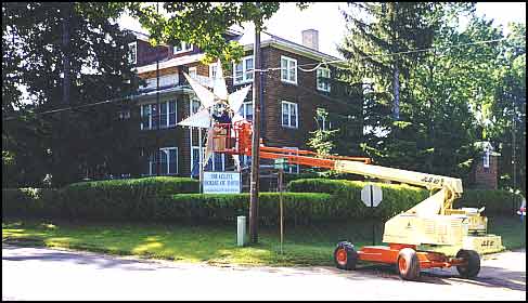 Colony electrician working on the Star lighting at the Administration building, 1999.